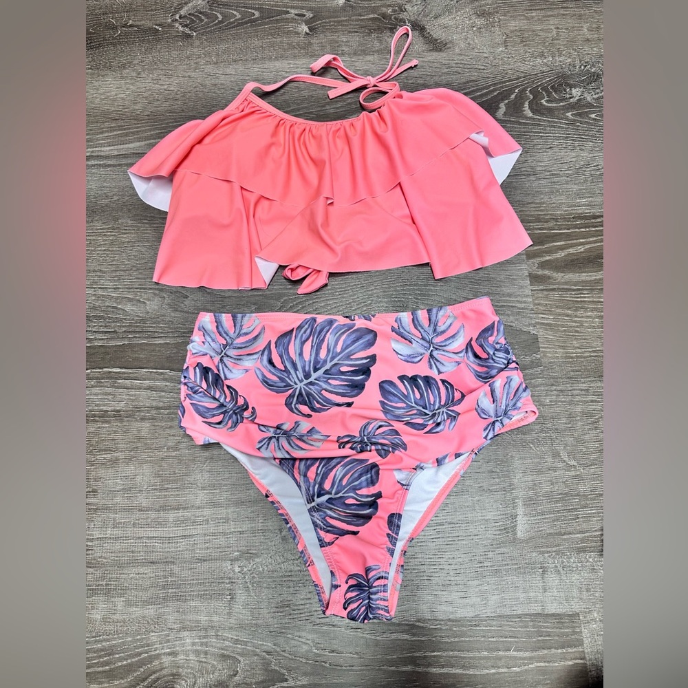 Women’s high waisted swimsuit with flounce top.
